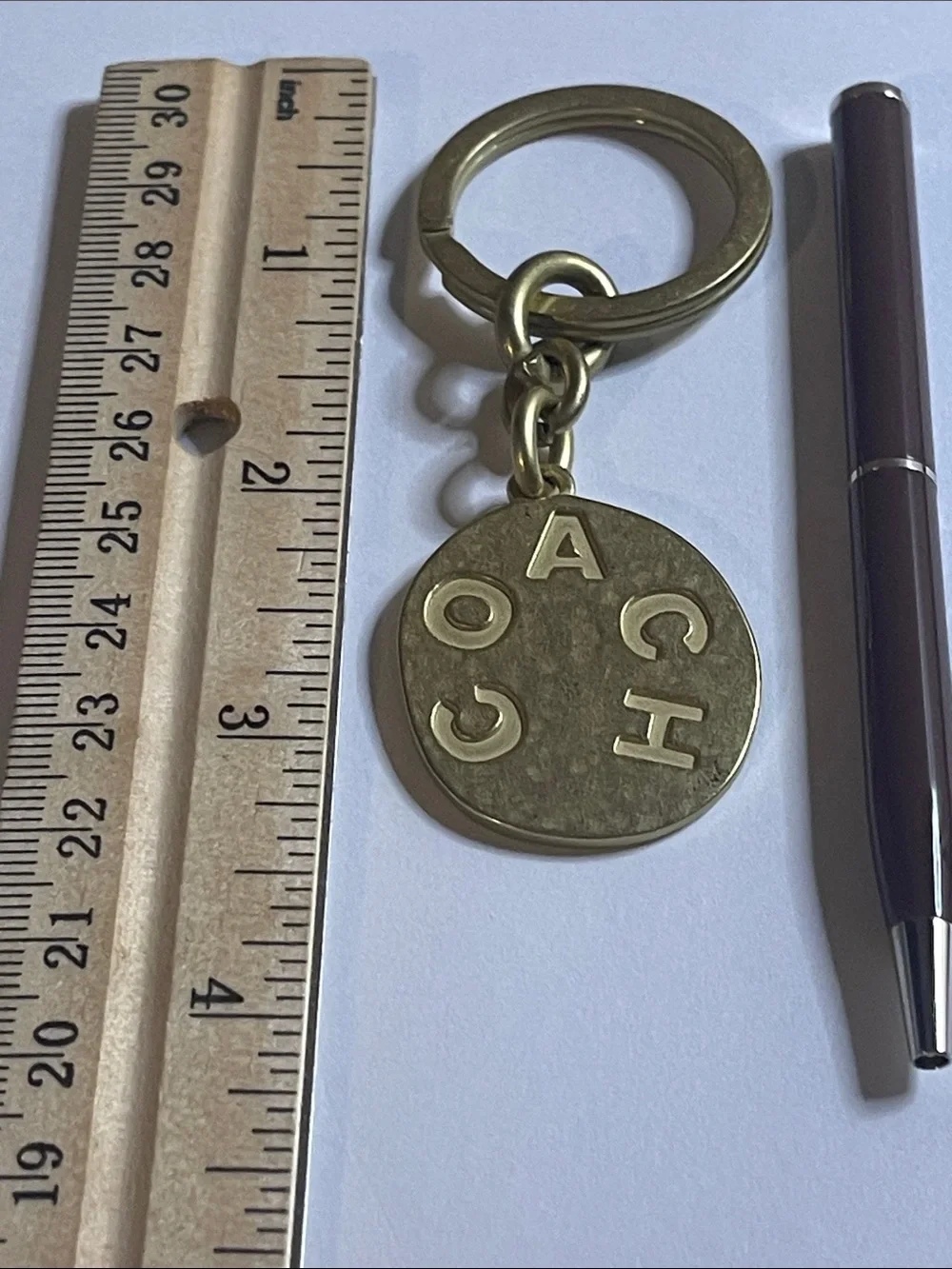 Coach Brass-Tone Round Logo Keychain and Coach Pen
